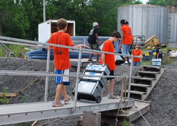 Students unload the ship's scientific gear.