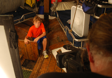 Mr. Woodworth films Nick checking the bilge in the galley.