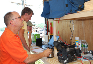 Captain Reynolds checks the dailies on a video monitor.