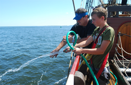 Lances washes up with the help of Nick and a hose.