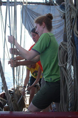 Carolyn and Elizabeth sweat the anchor tackle while Evi tails.