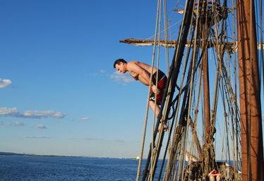 Lance dives into the water from the rig.