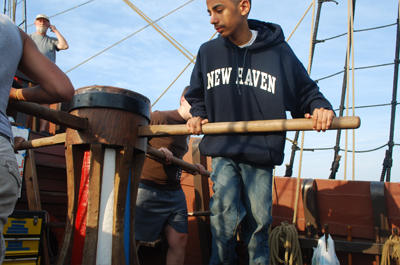 The crew walks the capstan.
