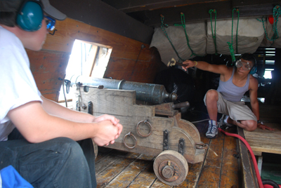 Eliu fires a salute from the starboard falconet.