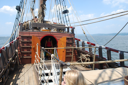 The crew hides from the sun under a tarp stretched over the capstan.