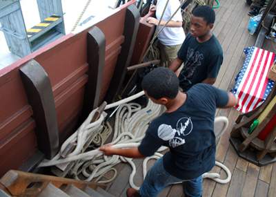 Clinton and Jason tend to two Line Three mooring lines made off on the same kevel.