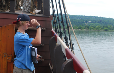Morgan lobs a small pice of wood into the river and is prepped to time it.
